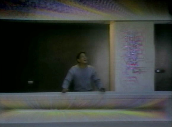 Raúl Juliá as Aram Fingal realizing the virtual reality around him in 'Overdrawn at the Memory Bank' (Williams 1983)